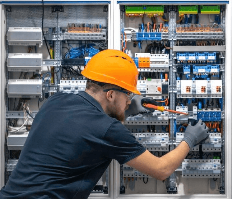 Electrician working on electrical panel